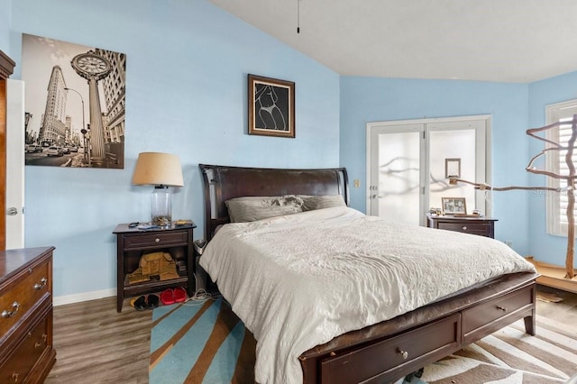 bedroom featuring hardwood / wood-style flooring and vaulted ceiling