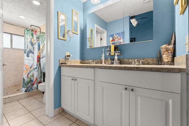 bathroom with vanity, curtained shower, tile patterned floors, and toilet