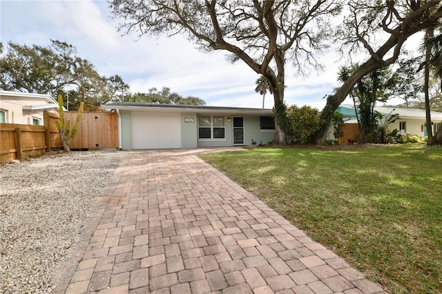 ranch-style house with a garage and a front yard