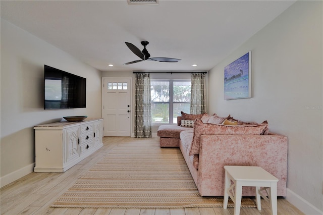 living room featuring ceiling fan and light hardwood / wood-style flooring