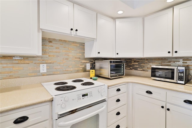 kitchen with white cabinetry, white electric stove, and decorative backsplash