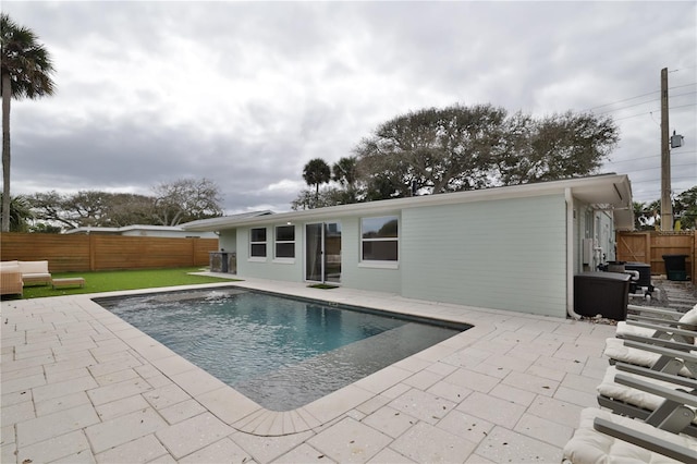 view of swimming pool with a lawn and a patio area