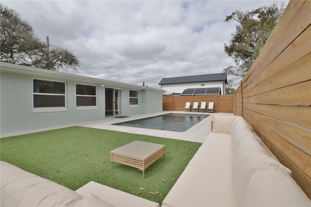 view of pool featuring a lawn and a patio