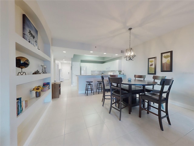 tiled dining space with a chandelier