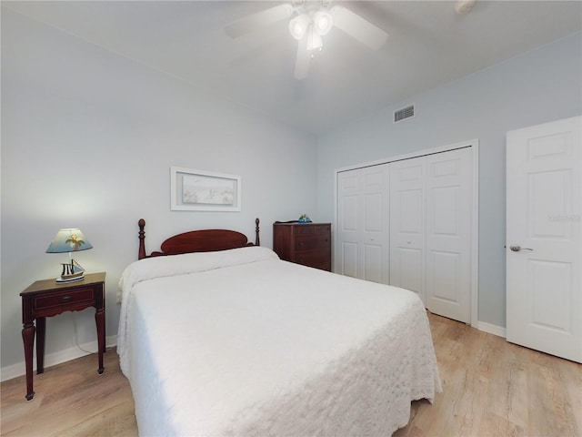 bedroom with a closet, ceiling fan, and light wood-type flooring