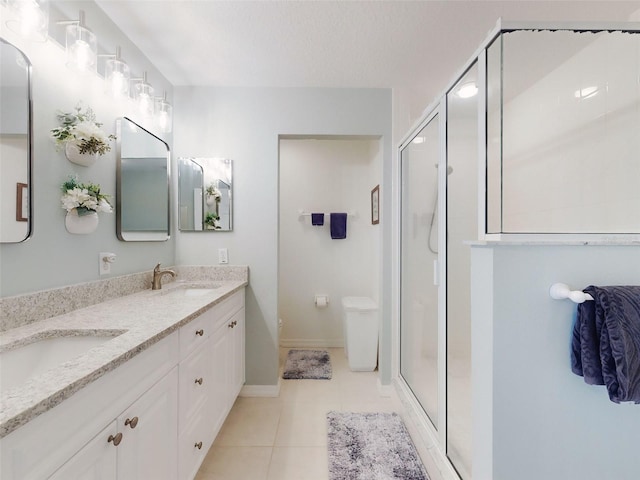 5300 S Atlantic Ave Unit 3-504, New Smyrna Beach, FL 32169 - full bathroom with double vanity, a shower stall, a sink, and tile patterned flooring