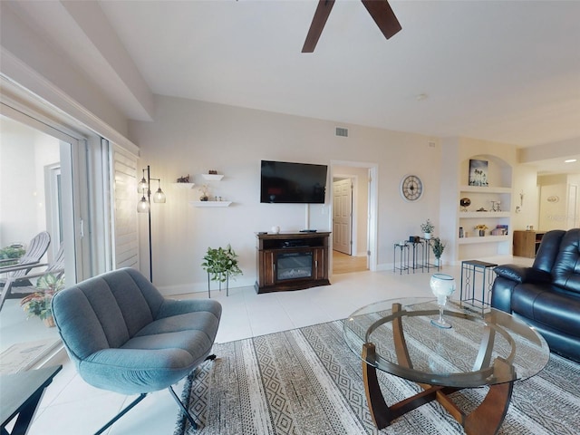 5300 S Atlantic Ave Unit 3-504, New Smyrna Beach, FL 32169 - tiled living area featuring visible vents, a fireplace, baseboards, ceiling fan, and built in shelves
