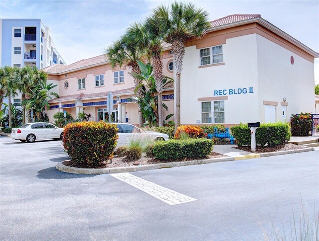 5300 S Atlantic Ave Unit 3-504, New Smyrna Beach, FL 32169 - view of building exterior with uncovered parking