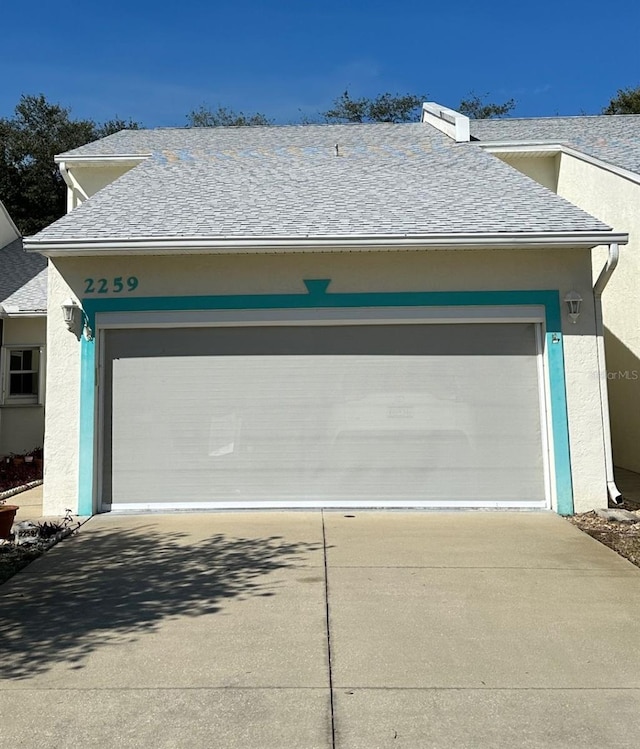 garage featuring concrete driveway