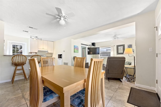 dining space with a textured ceiling and ceiling fan