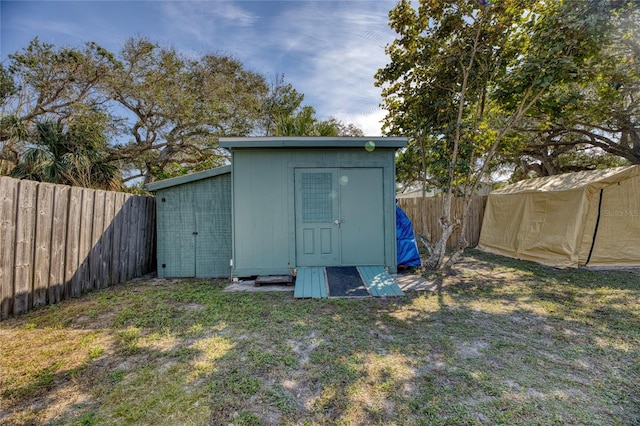 view of outbuilding featuring a lawn