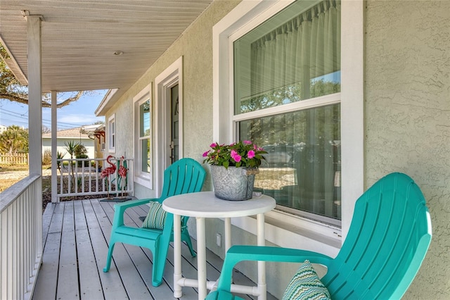 wooden terrace featuring covered porch