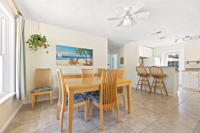 dining area with a textured ceiling and ceiling fan