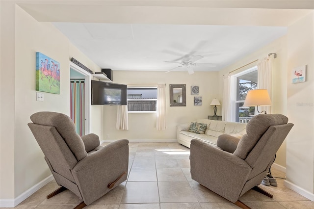 living room featuring ceiling fan and light tile patterned flooring