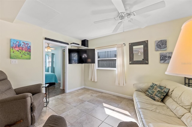 living room with light tile patterned flooring, a healthy amount of sunlight, and ceiling fan