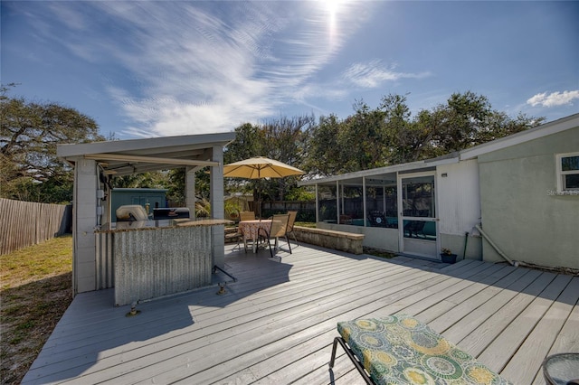 wooden deck with a sunroom