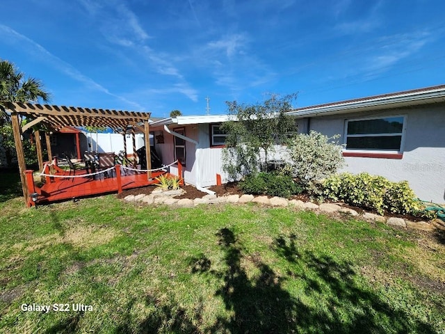 view of yard featuring a wooden deck and a pergola