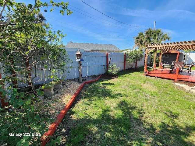 view of yard with a pergola and a deck