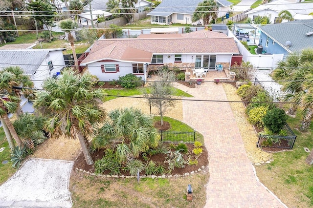 view of front of property with fence private yard, a residential view, and decorative driveway