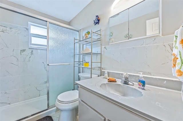 full bath with toilet, a stall shower, tile walls, and vanity