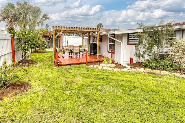 back of house with fence private yard, a lawn, a deck, and a pergola