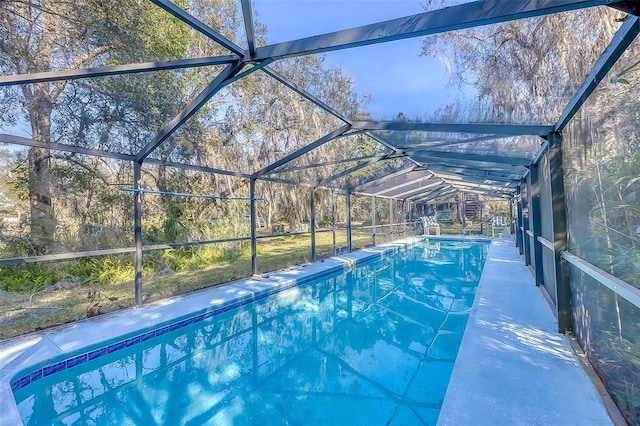 view of pool featuring glass enclosure