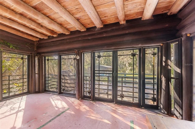 unfurnished sunroom featuring beamed ceiling and wooden ceiling