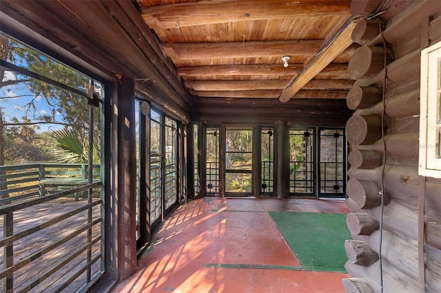 unfurnished sunroom with wooden ceiling and beam ceiling