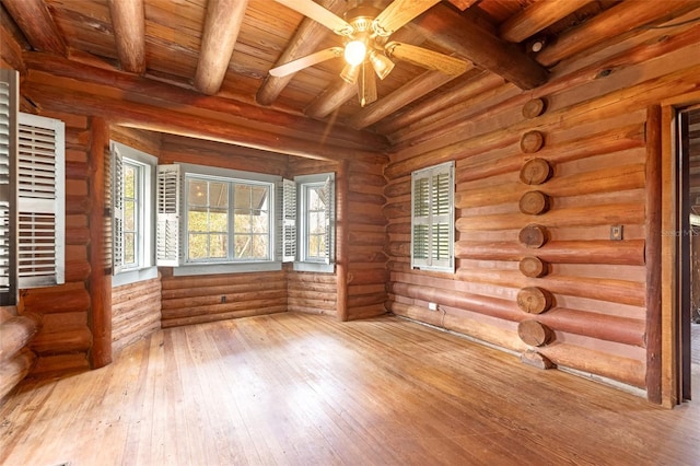 unfurnished sunroom featuring wood ceiling, ceiling fan, and beamed ceiling