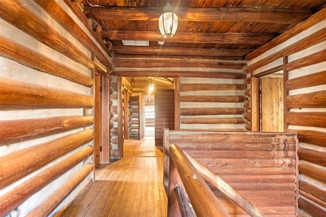 hallway featuring hardwood / wood-style flooring, wooden ceiling, and beam ceiling