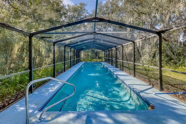 view of pool featuring glass enclosure