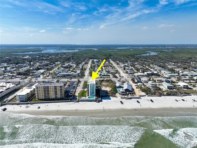 drone / aerial view with a water view and a beach view