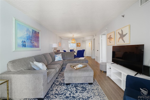 living room featuring wood-type flooring and a textured ceiling