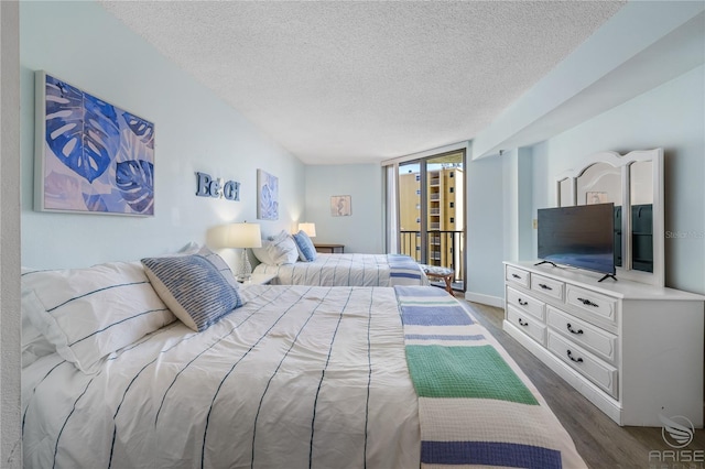 bedroom featuring dark wood-type flooring and a textured ceiling