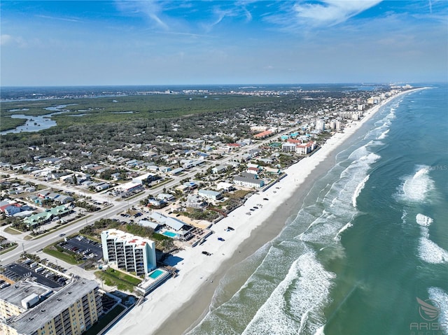 bird's eye view featuring a water view and a beach view