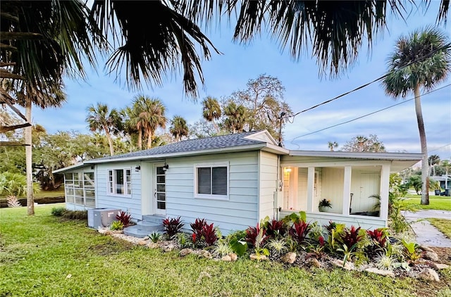 rear view of house featuring a yard