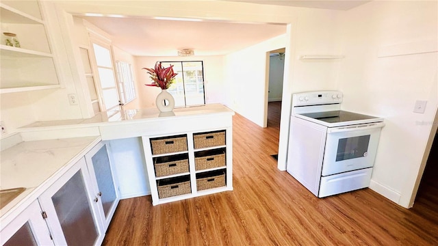 kitchen featuring electric range and light hardwood / wood-style floors