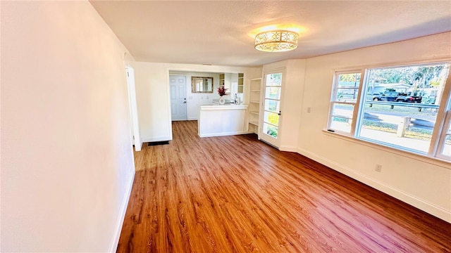 interior space with light hardwood / wood-style floors and built in features