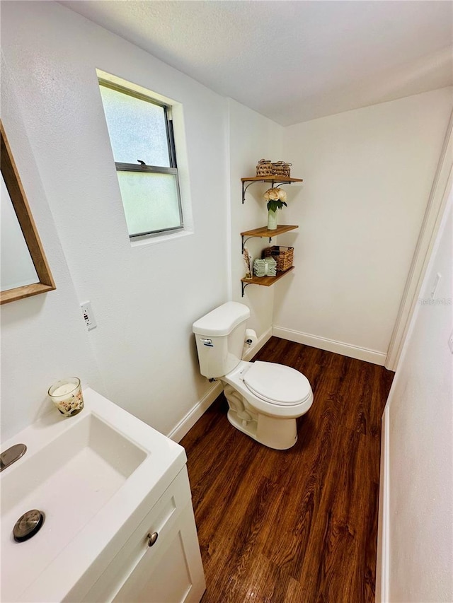 bathroom featuring sink, hardwood / wood-style floors, a textured ceiling, and toilet