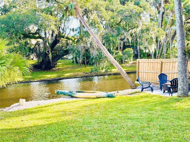 view of community featuring a water view and a lawn