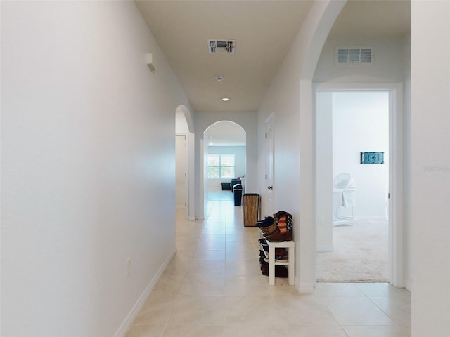 corridor with light tile patterned floors