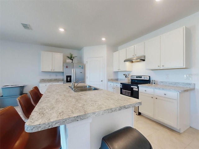 kitchen featuring a kitchen island with sink, a breakfast bar, white cabinets, and appliances with stainless steel finishes