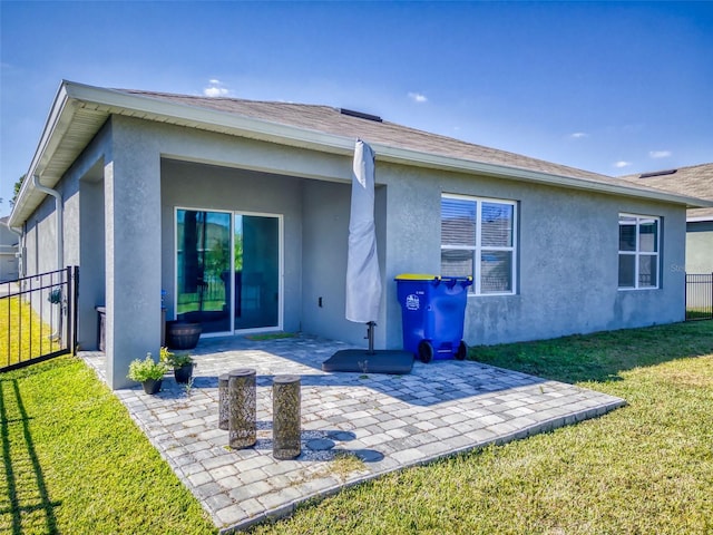 back of house featuring a yard and a patio