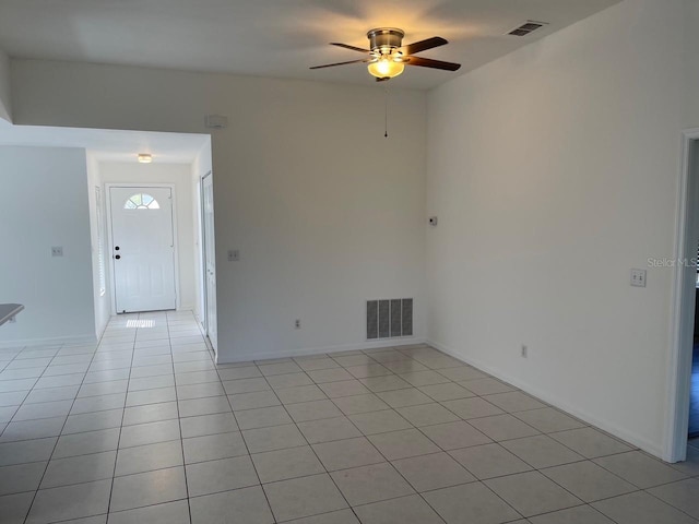 empty room with visible vents, a ceiling fan, baseboards, and light tile patterned floors