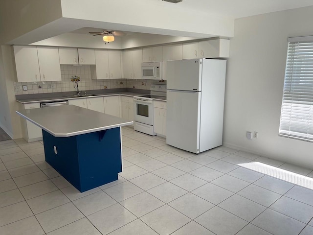 kitchen with ceiling fan, a sink, white appliances, and light tile patterned floors