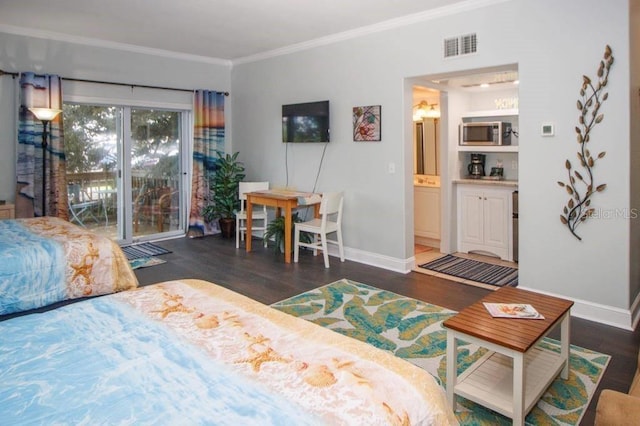 bedroom featuring dark hardwood / wood-style flooring, access to exterior, and crown molding