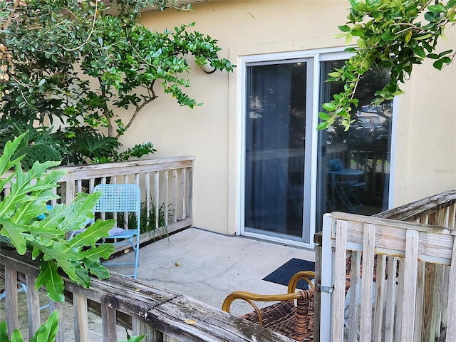 view of exterior entry featuring a patio area