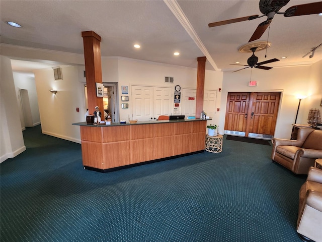 welcome area featuring ornate columns and ceiling fan