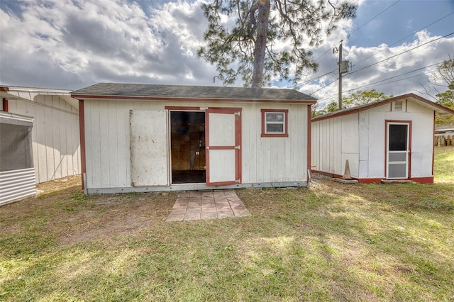 view of outbuilding featuring a lawn