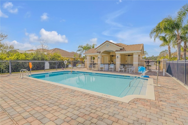 view of swimming pool with a patio and ceiling fan